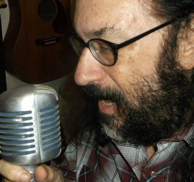 Guy Schwartz singing into a vintage microphone